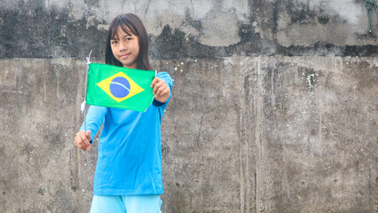 a little girl with the brazil flag
