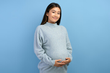 Image of a beautiful young pregnant asian woman posing isolated - Powered by Adobe