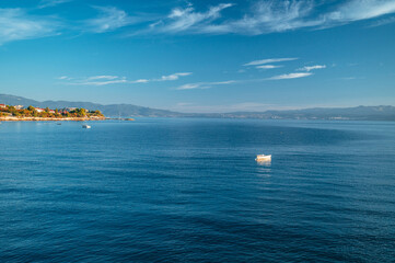 Alone Boat in clear blue Mediterranean sea. Summer Vacation photo. Edit space.