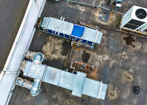 Ventilation And Air Conditioning System On The Roof Of An Office Or Industrial Building. View From Above. Air Cleaning. Drone Photography.