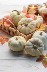 Autumn leaves and pumpkins over old wooden background