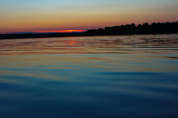 Fototapeta na wymiar water lake surface at dusk at sunset