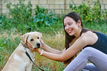 young woman with her lovely dog on a summer day - 543607020