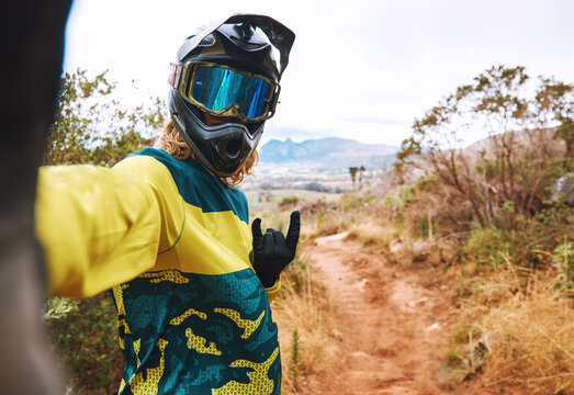 Sports, biker selfie and cycling in nature, countryside or outdoors. Bmx, rock hand sign or self portrait of cyclist on sand or dirt road for adventure, memory or online picture post on social media