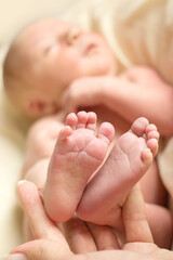 Baby feet in mother hands. Mom and her Child. Happy Family concept