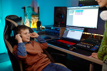 Children at recording studio boy listening new soundtrack