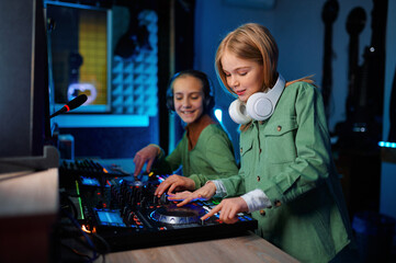 Children using sound mixer in radio station