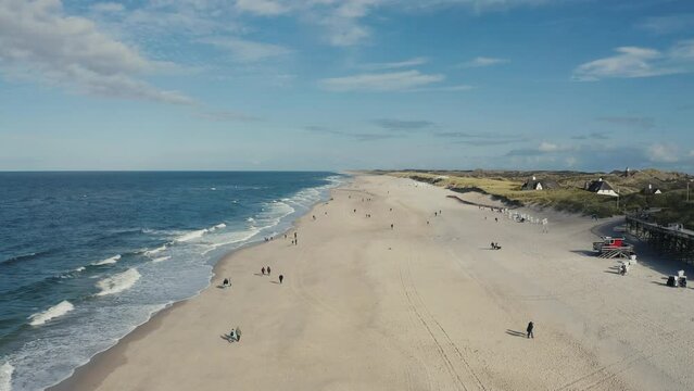 Aerial view of beach. Sylt, Germany, Schleswig-Holstein.  Beautiful sea waves. Sand and amazing sea. Summer seascape. North Sea. Atlantic Ocean beach. Water texture. 4K drone