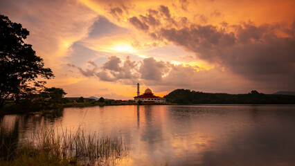 Beautiful view of Darul Quran mosque with reflections during sunset at Kuala Kubu, Selangor, Malaysia. The image may has blurred effect and soft focus due to long exposure.