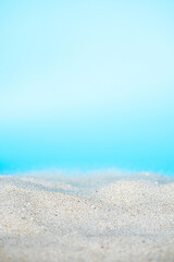 Fototapeta na wymiar Sea beach sand texture on blue background with selective focus. Summer background. 