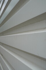 PVC white grooved wall fencing construction site. Converging grooves pattern background