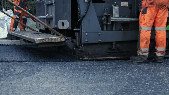 Road Paving Machine Roadworks Asphalt Laying Machine Operated by Workers Wearing Protective Workwear