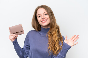Obraz premium Young pretty woman holding wallet isolated on white background saluting with hand with happy expression