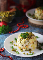 Olivier salad, traditional Russian dish, served on the plate for New Year dinner