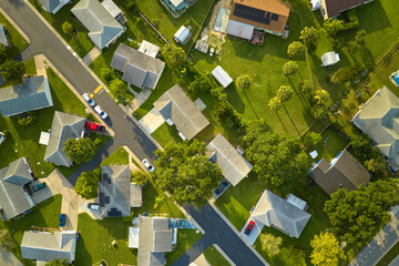 Aerial landscape view of suburban private houses between green palm trees in Florida quiet rural...