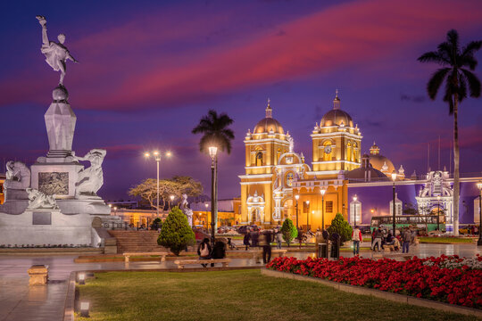 View of Plaza de Armas (Main Square), with the grand Cathedral and its bright yellow facade, Trujillo, Peru