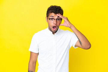 Fototapeta premium Young handsome Brazilian man isolated on yellow background has realized something and intending the solution