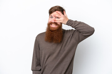 Redhead man with beard isolated on white background covering eyes by hands and smiling