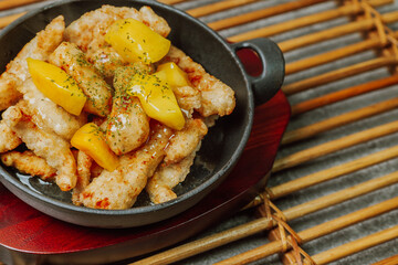Chinese food sweet and sour pork dish in black bowl