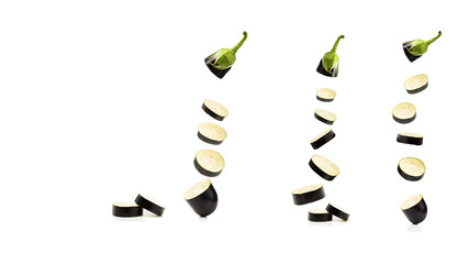 Levitation of eggplant fruit cut into slices on a white background