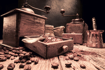 Milled coffee beans in bag and grinder with ground coffee