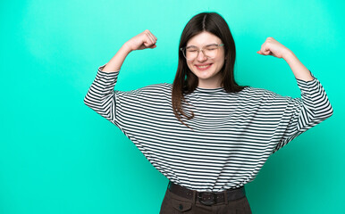Young Russian woman isolated on green background doing strong gesture