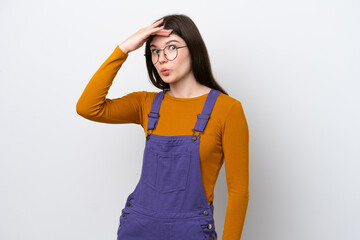 Young Russian woman isolated on blue background doing surprise gesture while looking to the side