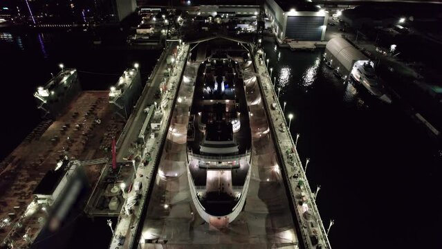 Passenger ferry undergoing maintenance on dry-dock, port, industrial. 4K 24FPS