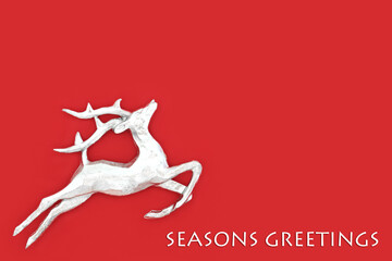 Seasons greetings Christmas Eve reindeer festive red background. Minimal design for winter, Xmas...