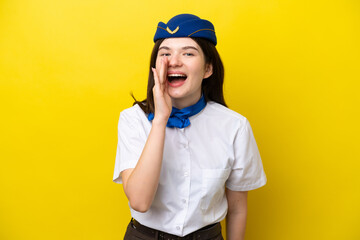 Airplane stewardess Russian woman isolated on yellow background shouting with mouth wide open