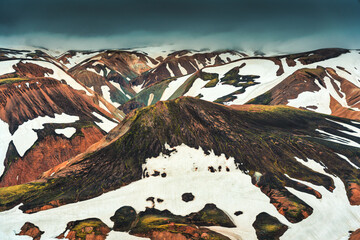 Scenery of volcanic mountain and snow covered in Blahnjukur trail on Icelandic highlands at...