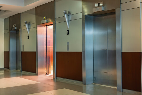 An elevator with open doors and an illuminated interior invites you to drive.