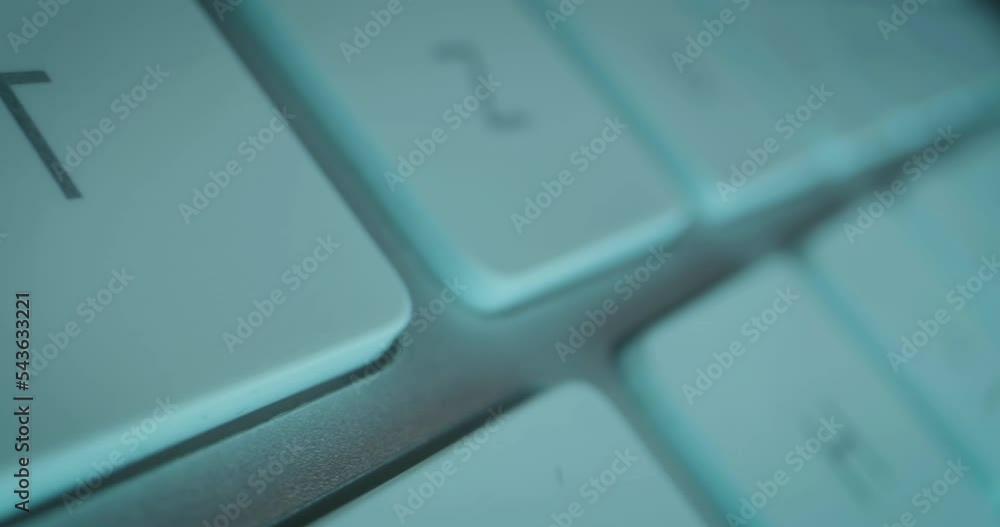 Poster extreme close-up tracking shot over individual keys of technical computer keyboard