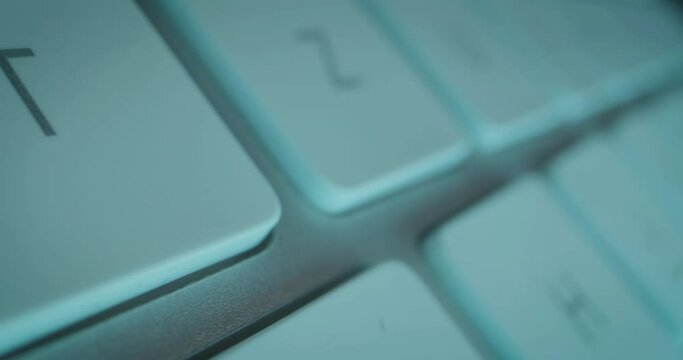 Extreme close-up tracking shot over individual keys of technical computer keyboard
