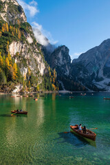 Fototapeta na wymiar Boats on the Braies Lake ( Pragser Wildsee ) in Dolomites mountains, Sudtirol, Italy
