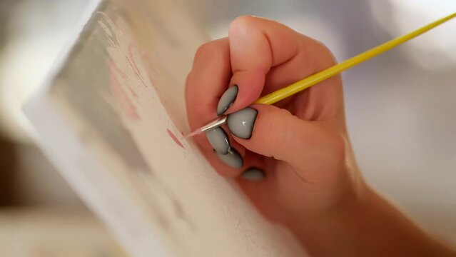 close up of artist woman's hand with brush painting picture on canvas in art studio sunset artists studio creativity drawing design girl pattern ornament art colourful paper fine art color slow motion