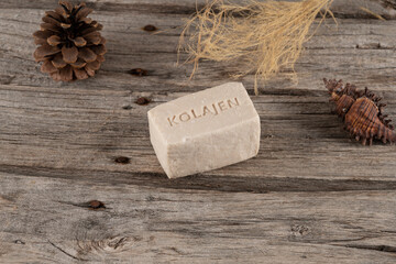 natural collagen soaps made with donkey milk stil life photo. on wooden background and soap, soap with collagen written on it