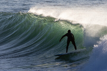 silhouette of a surfer in action