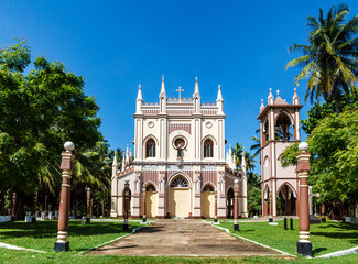 Fototapeta na wymiar Exterior of a Neo Gothic church with bell tower in Negombo, Sri Lanka, Asia