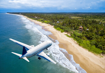Plane landing at tropical resort, jet flies over ocean beach and rainforest