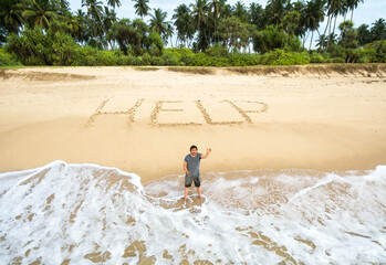 Man stuck on uninhabited island, inscription HELP on sand