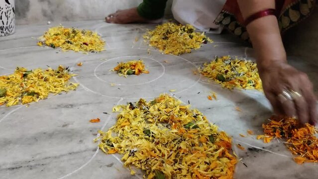 Time lapse footage of a girl making rangoli on the occasion of Diwali with flowers. Deepavli or Dipawali celebration and decoration.
