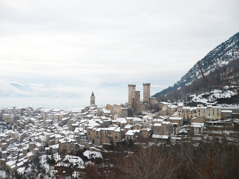 Snowy view of Pacentro and the Caldora or Cantelmo castle that dominates the houses of the characteristic mountain town - Abruzzo - Italy