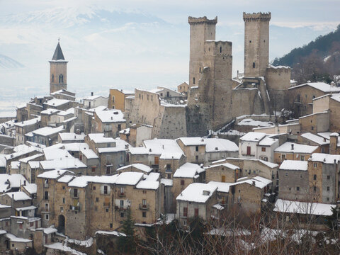 Snowy view of Pacentro and the Caldora or Cantelmo castle that dominates the houses of the characteristic mountain town - Abruzzo - Italy