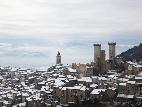 Snowy view of Pacentro and the Caldora or Cantelmo castle that dominates the houses of the characteristic mountain town - Abruzzo - Italy