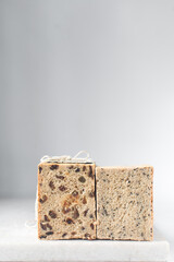 sesame seed bread and raisin bread	on a cutting board, different types of homemade bread