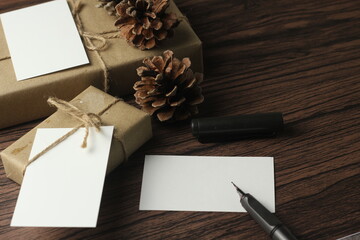 A birthday gift box wrapped in recycled paper is being prepared on the table.