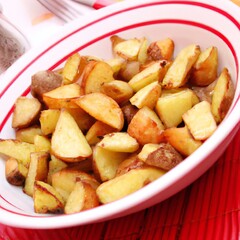 Crispy golden roast potatoes in a bowl