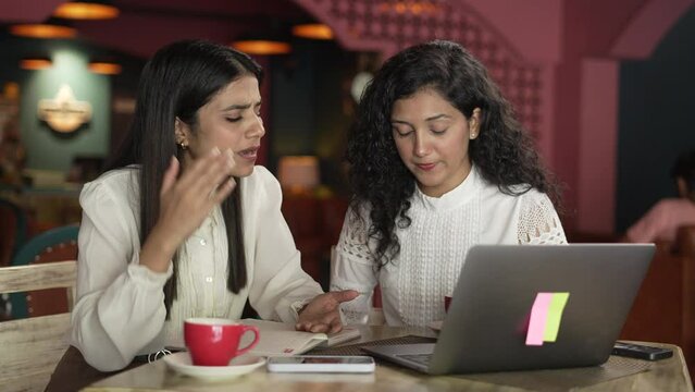 portrait of Indian woman boss  angry on his staff employees While sitting at desk in coffee shop.Angry Asian woman employee for bad results.Negative emotions facial expressions feelings unhappy.