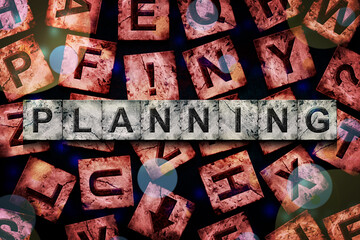 Planning, word on an alphabet on stone blocks, on a red background, with different letters.